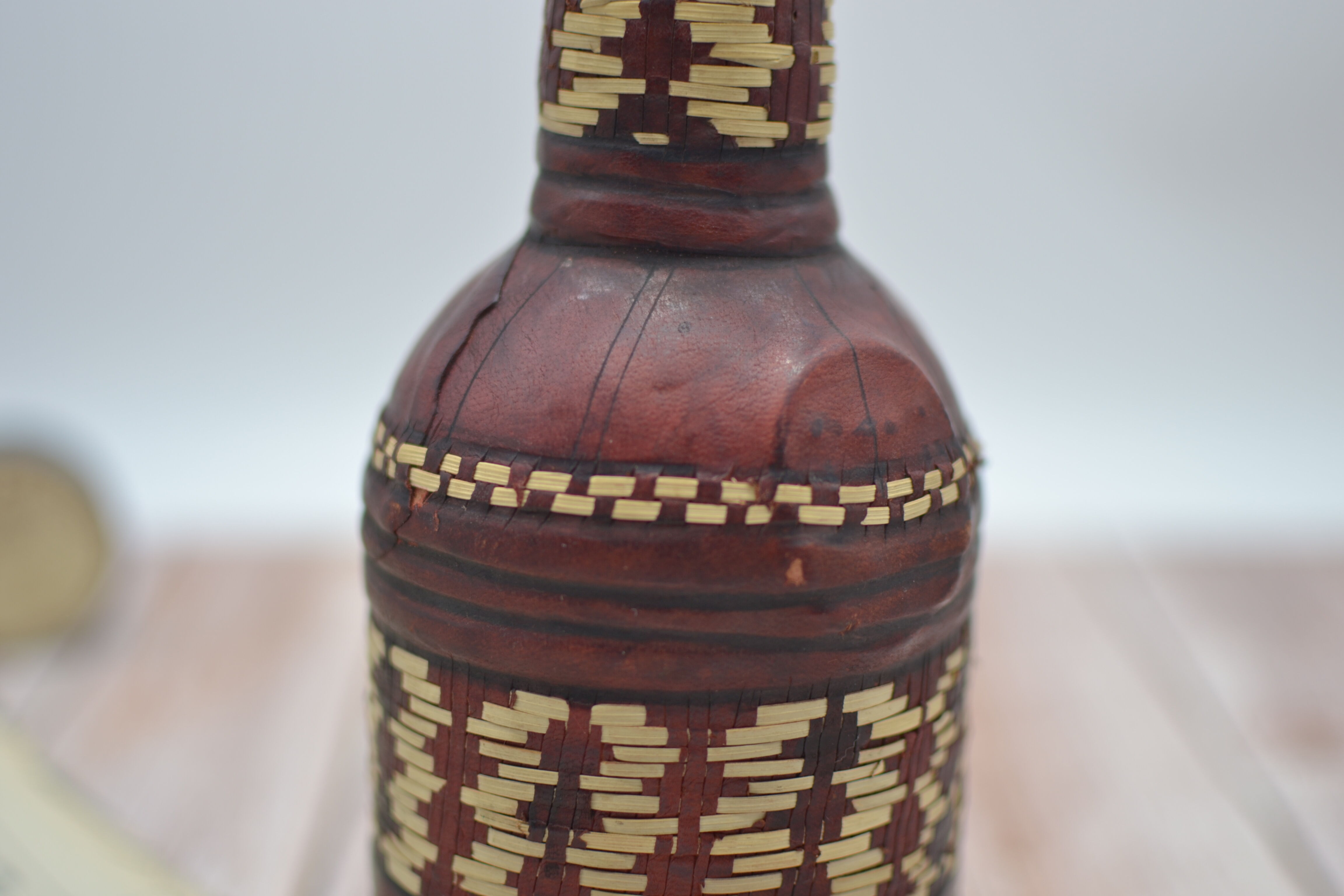 Set of 2 decorative vintage bottles covered with leather & wicker
