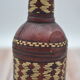 Set of 2 decorative vintage bottles covered with leather & wicker