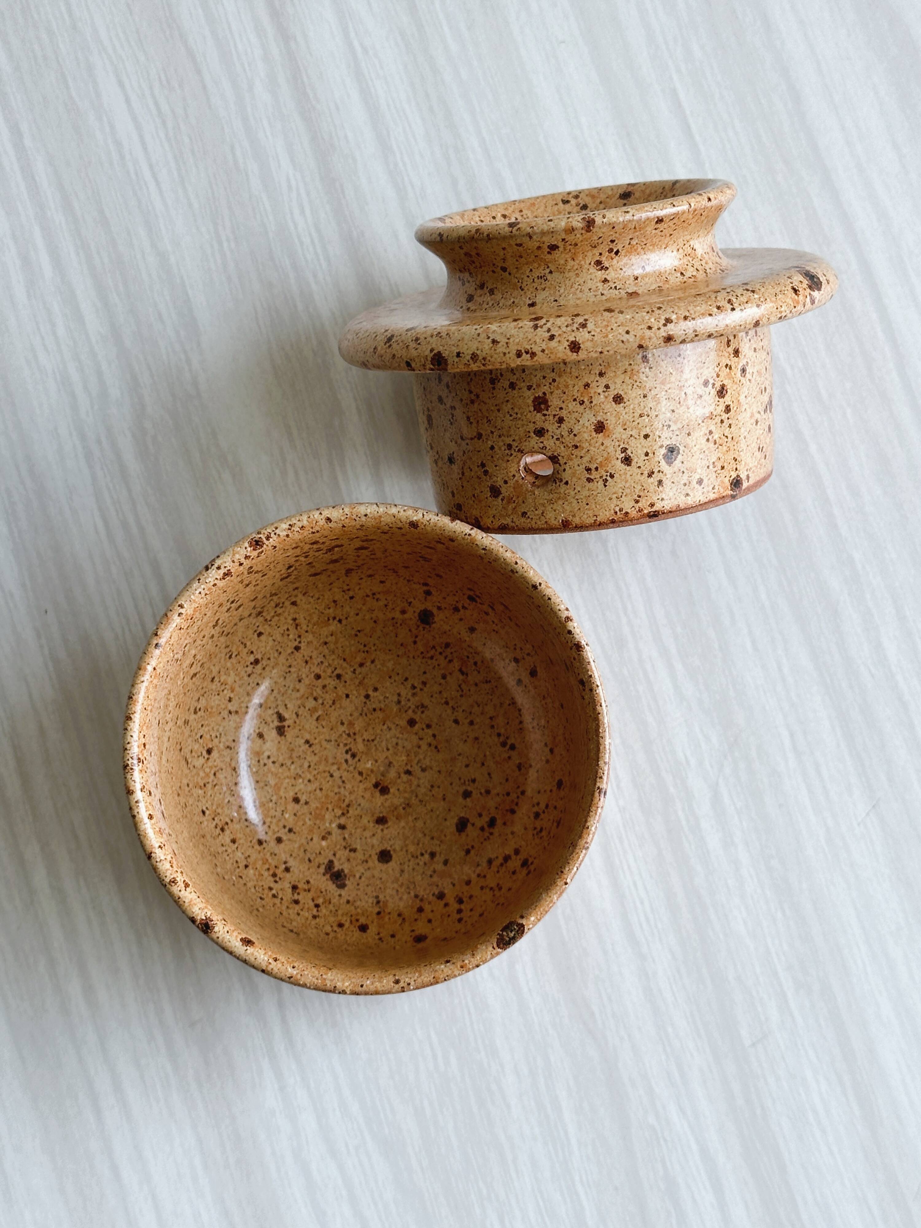 Small speckled ceramic butter dish, hand-painted decoration.