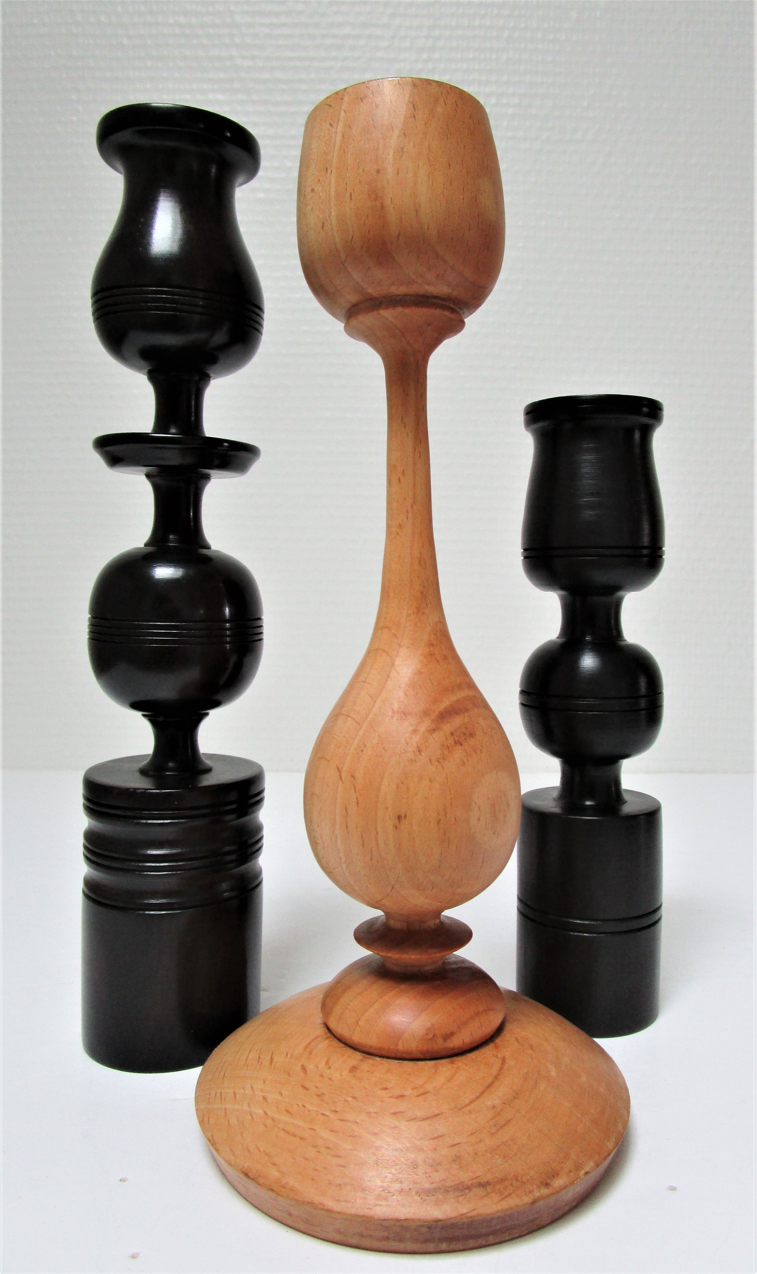 Three vintage light and dark wood candlesticks