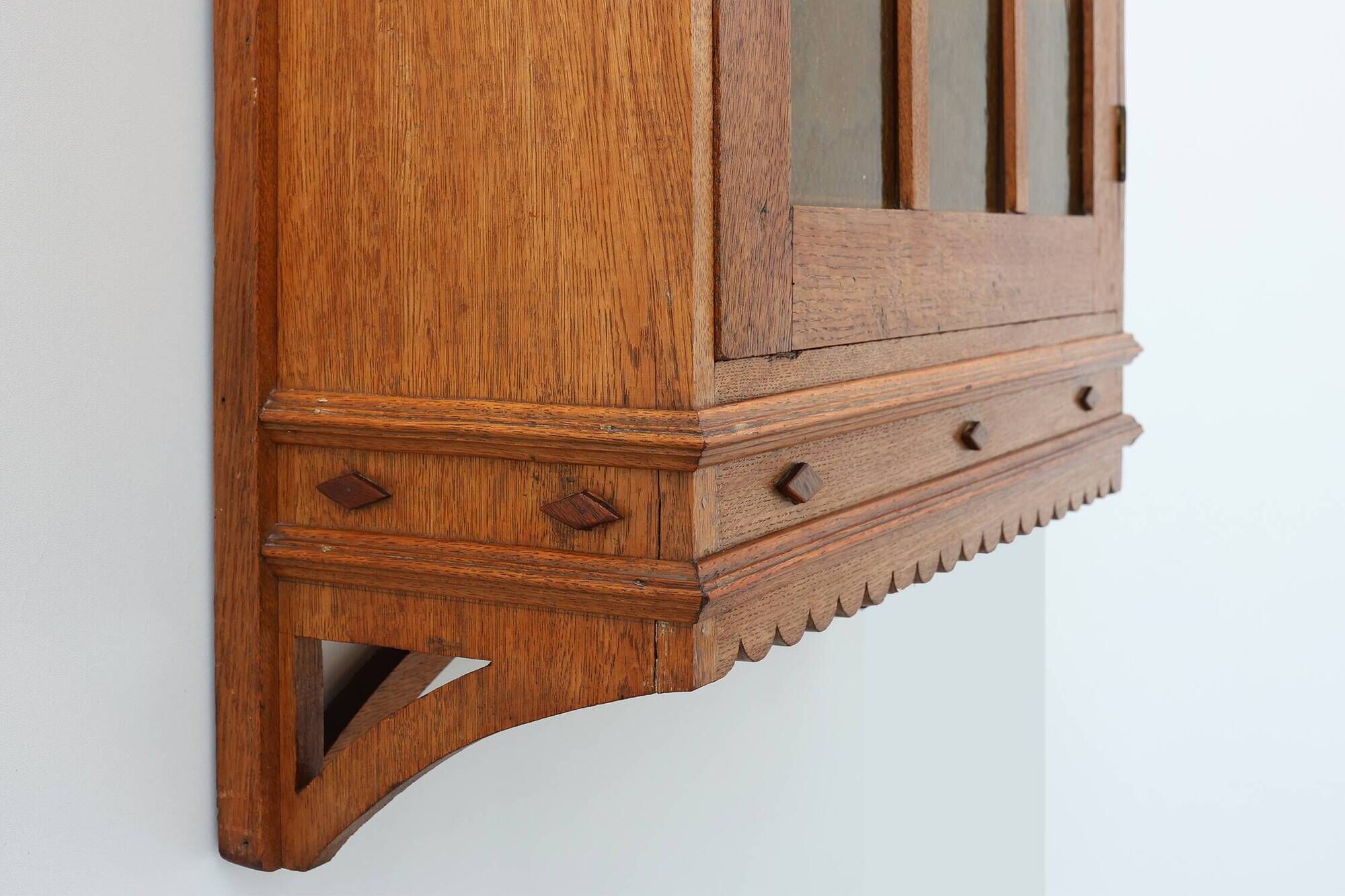 Art Deco oak wall cabinet with amber glazed door, Belgium ca. 1925