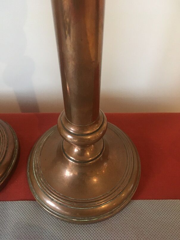 Pair of red brass candlesticks