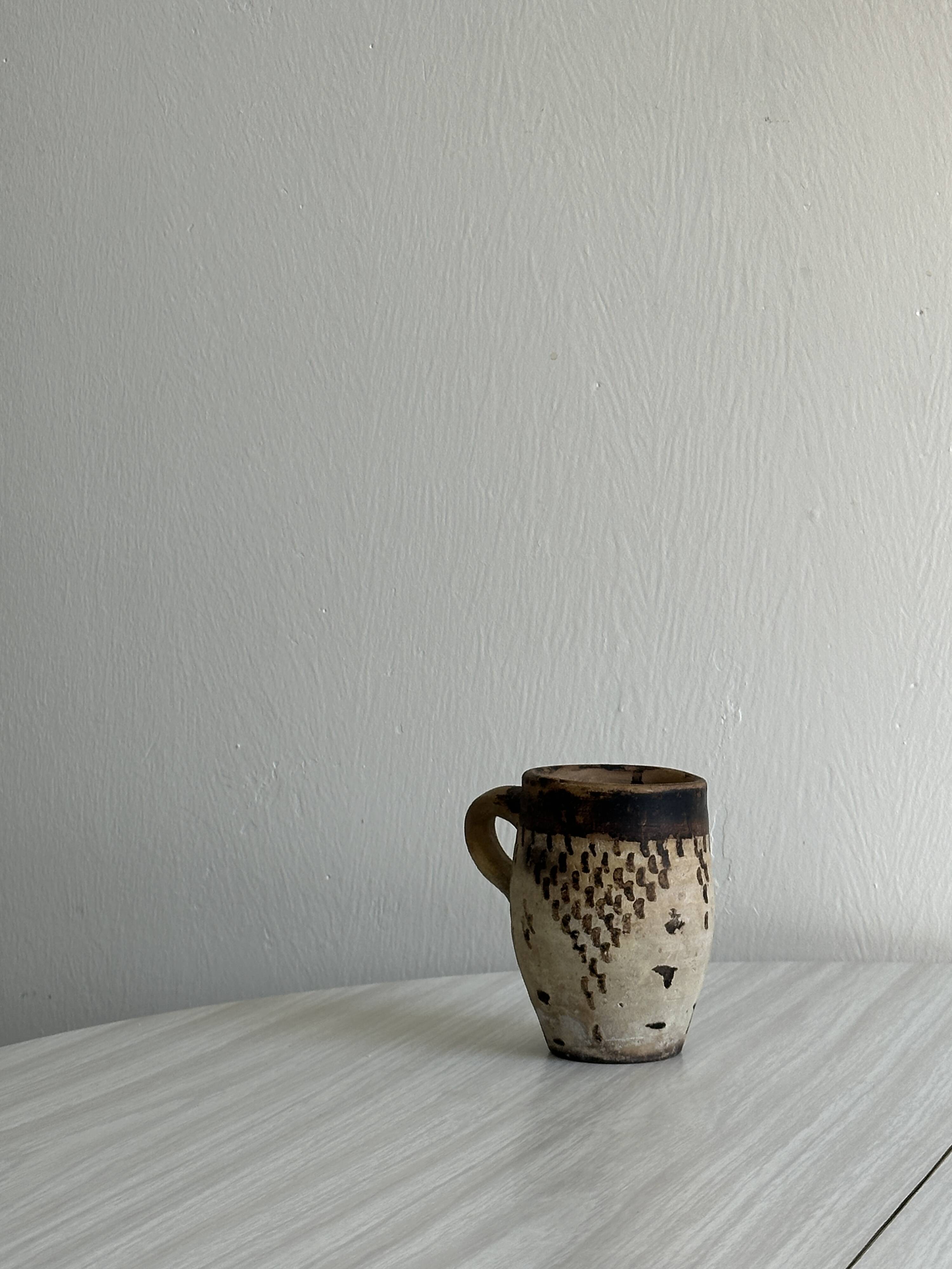 Small old terracotta cup