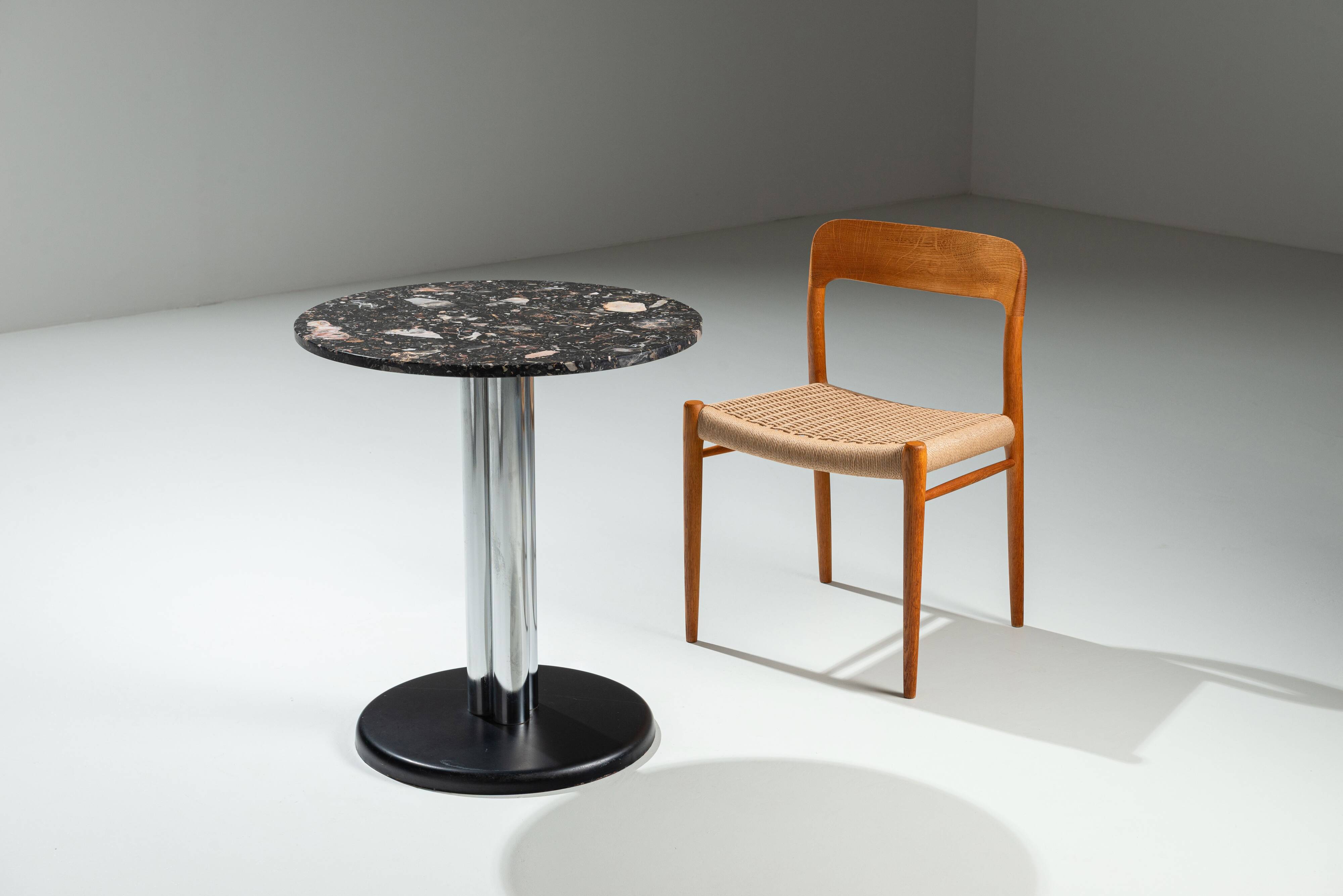 Round sidetable with stone top and three chromed legs