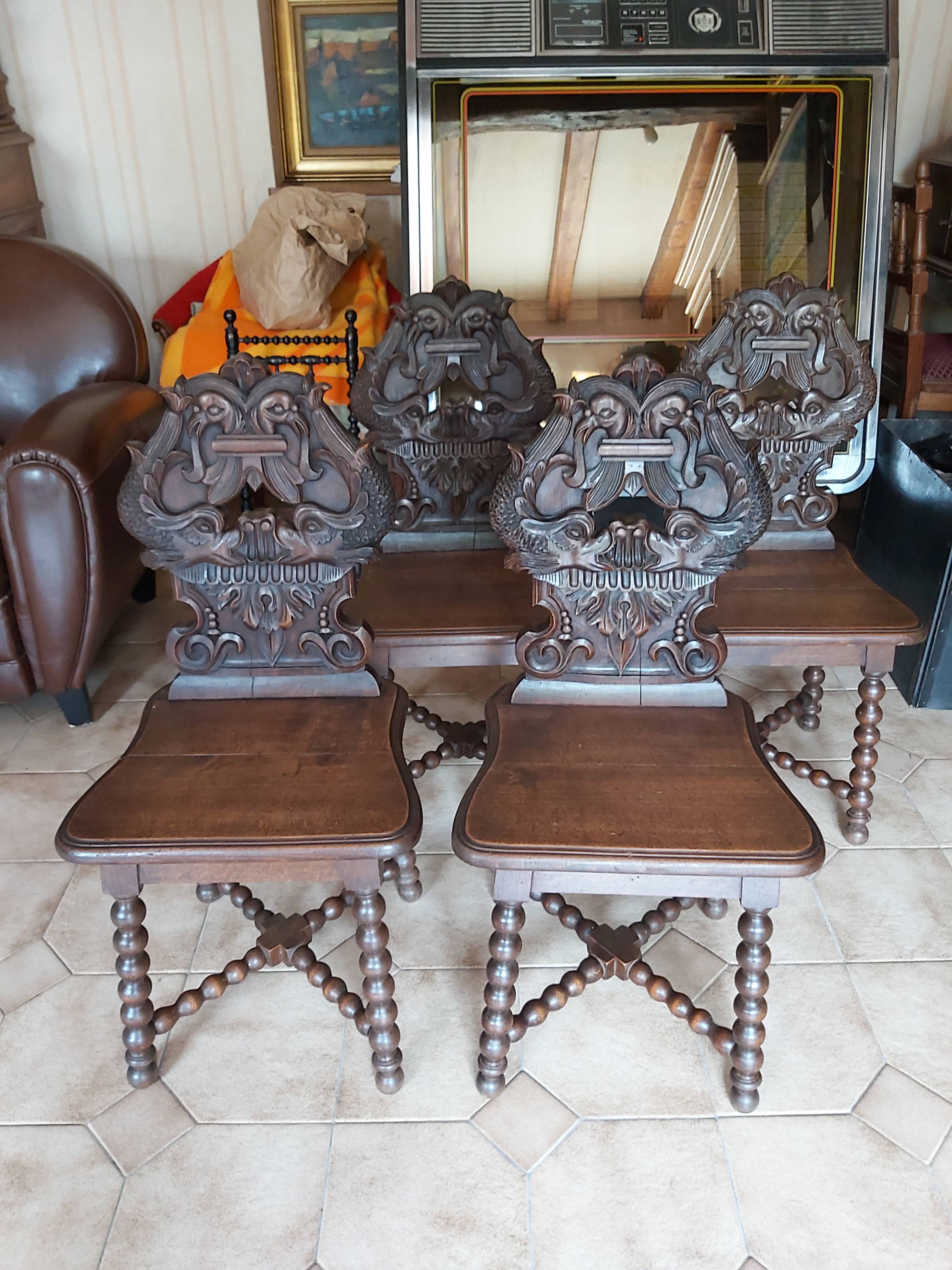 4 stylized dolphin back chairs