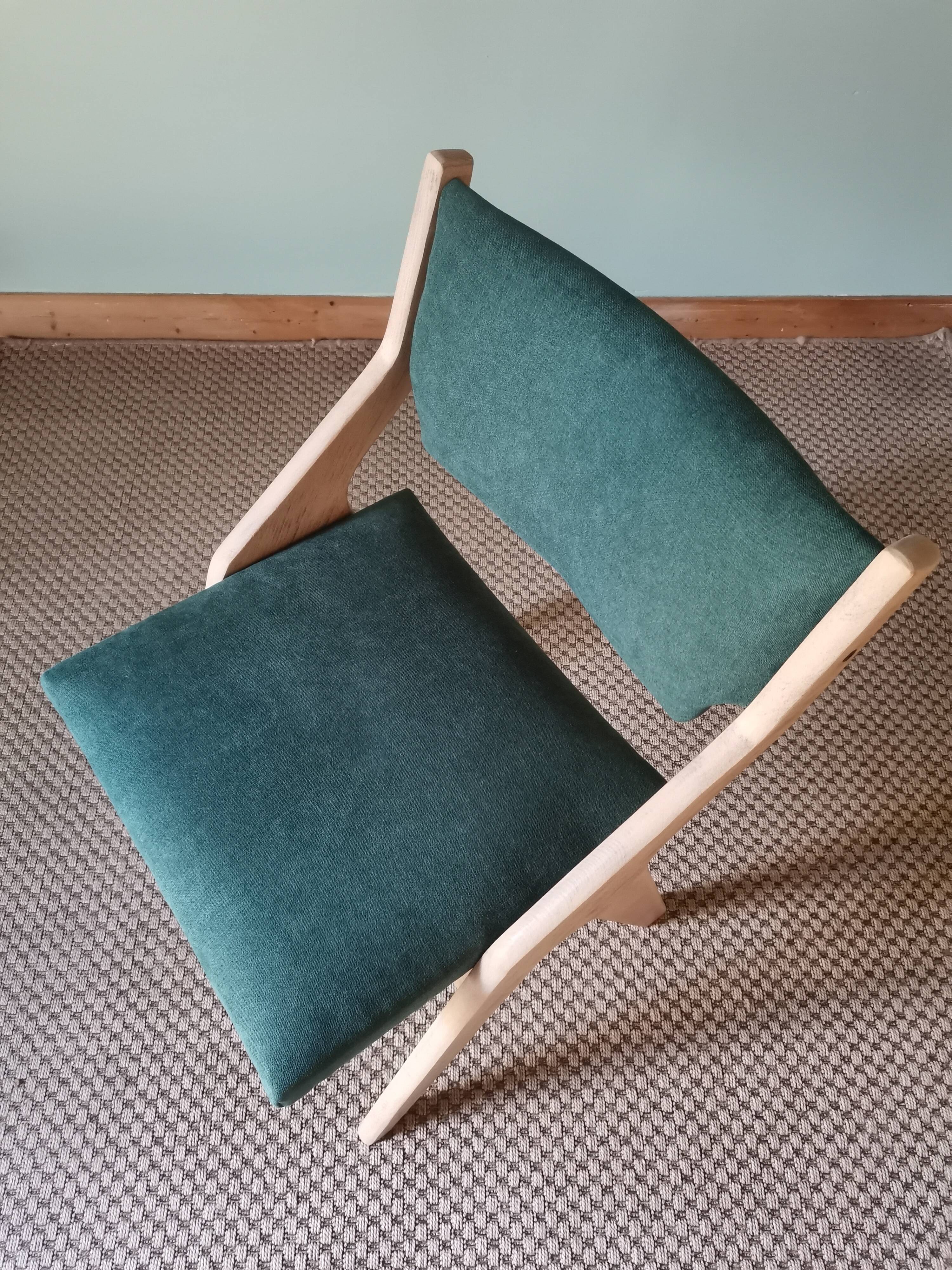 Scandinavian green chairs with tapered legs.