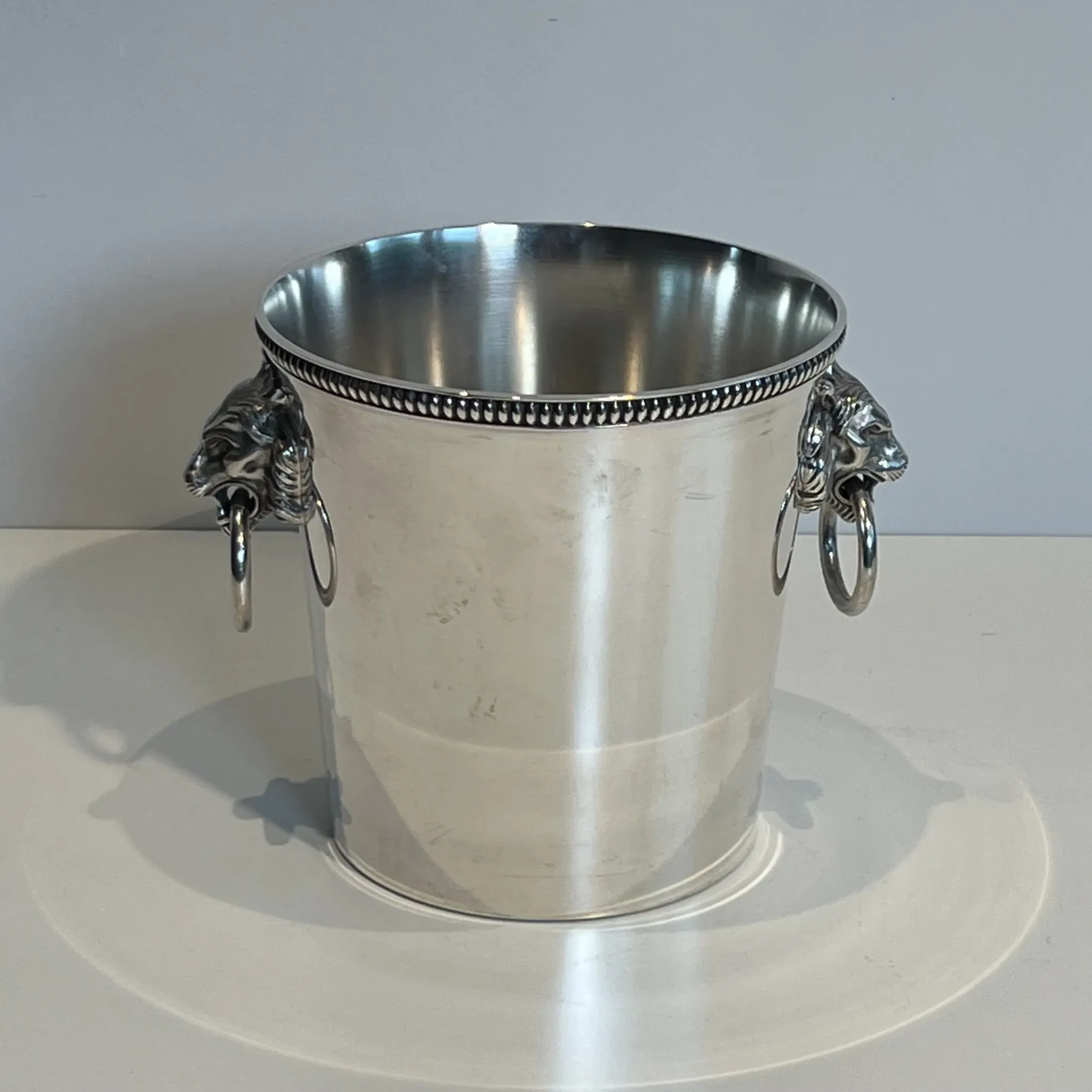 Silver-plated champagne bucket Orfèvrerie Saint-Médard. Handles in the shape of heads.