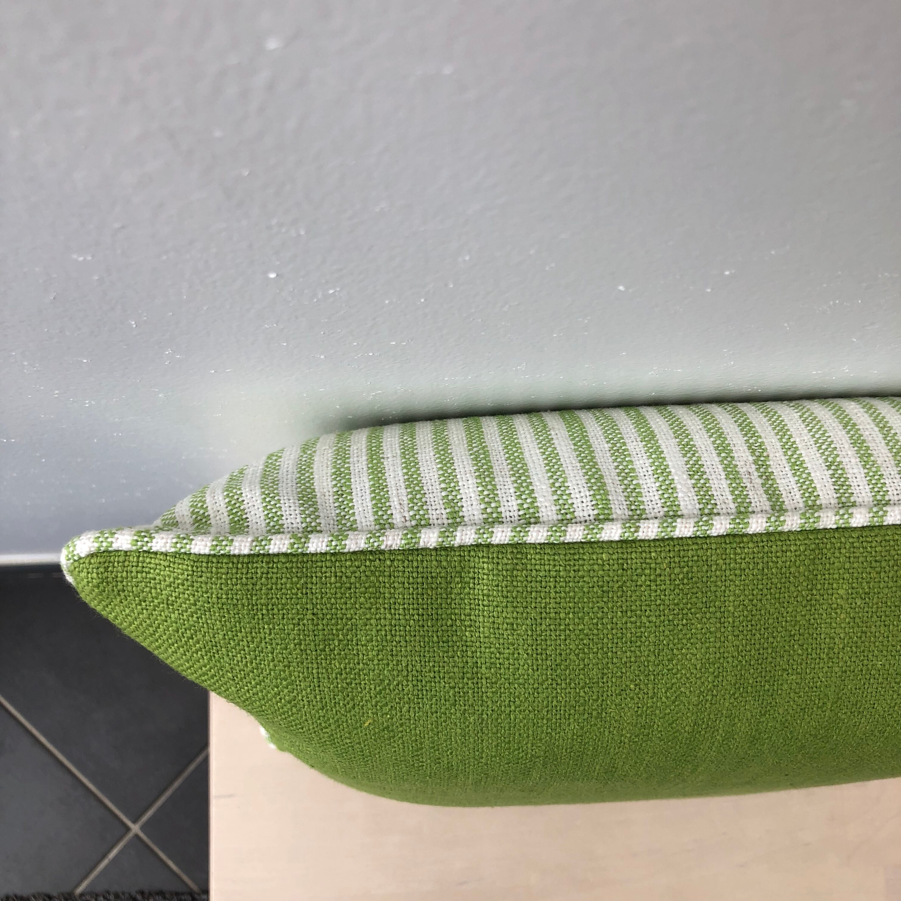 Green and white striped cushion