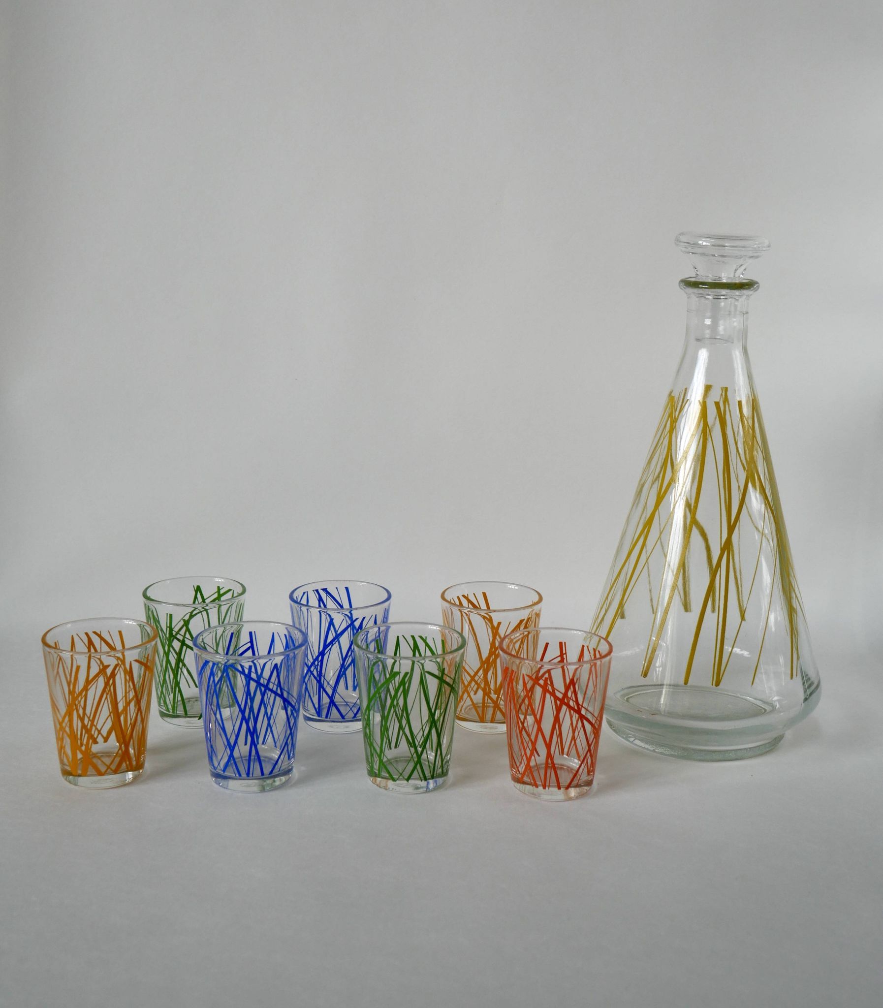 Colorful designer set composed of 7 liqueur glasses and a seventies 70s carafe