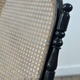 Rocking-chair en bois courbé noirci et cannage années 1900