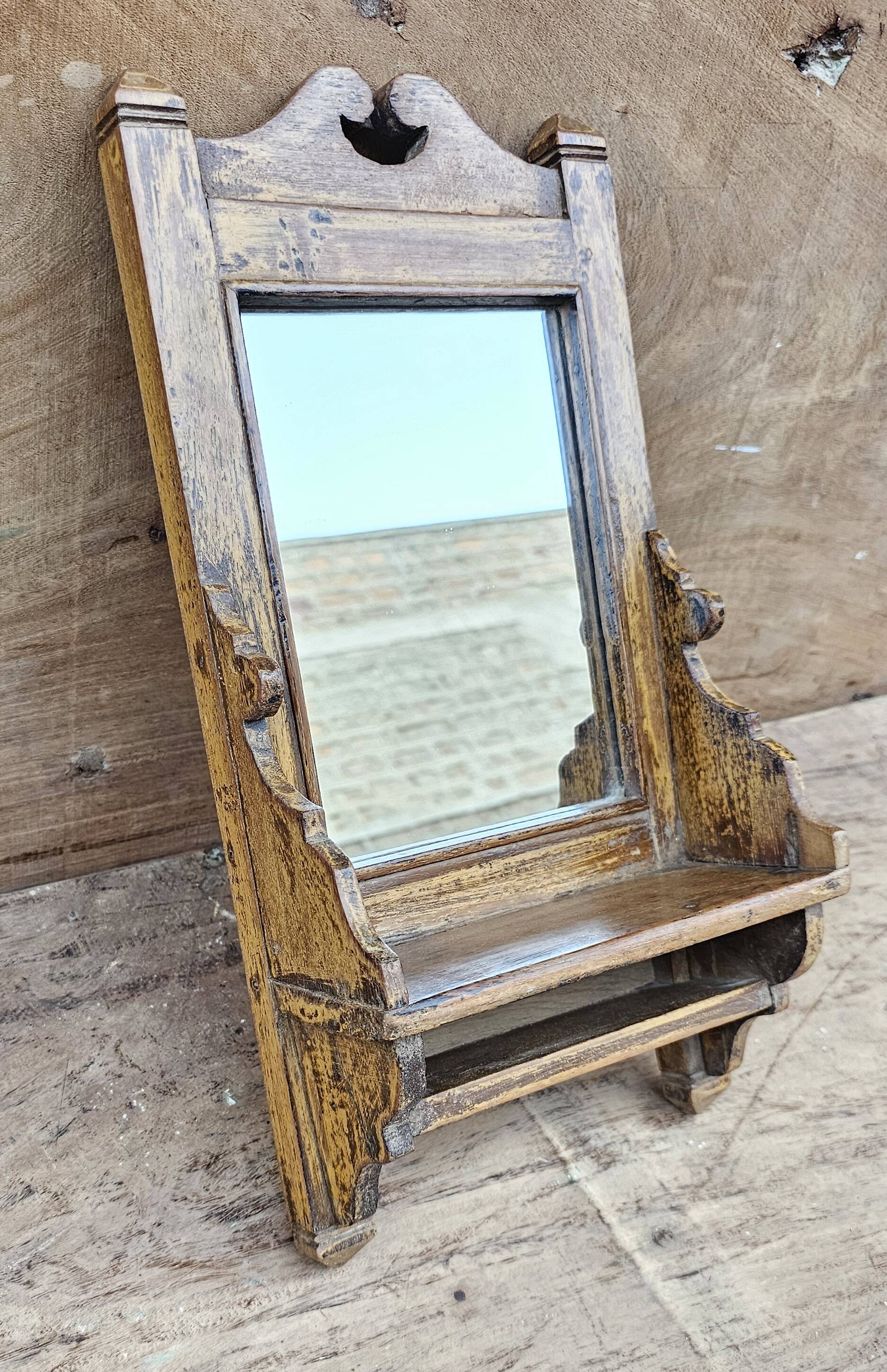 Antique barber's mirror in Burmese teak.