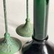 Green glass and metal candle holders