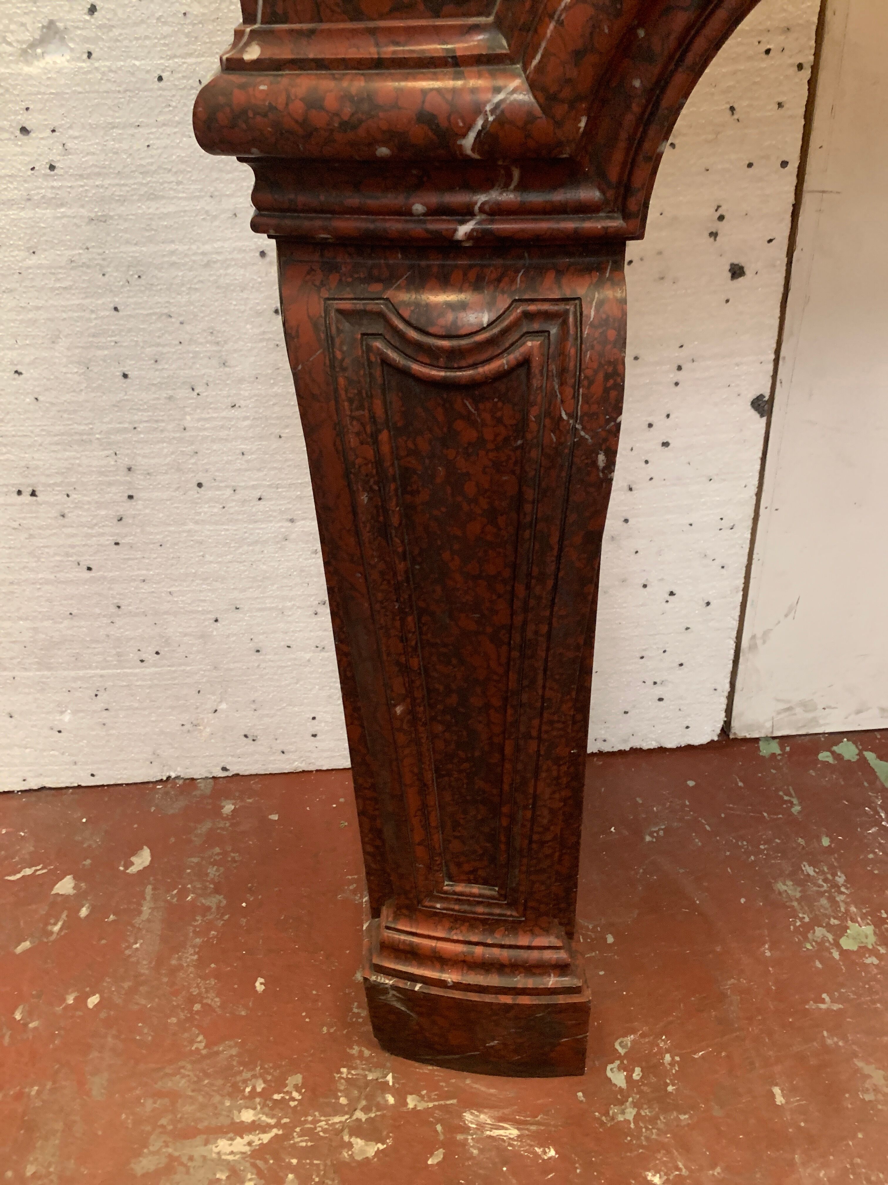 Pair of Louis XIV style fireplaces in red cherry marble. XIX century.