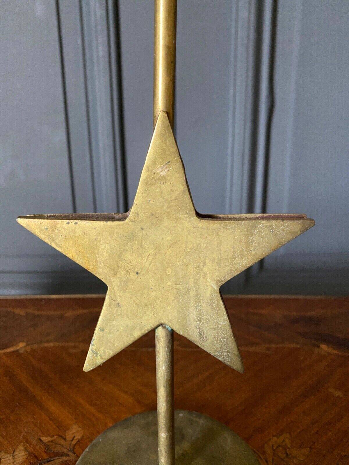 Pair of brass candlesticks decorated with 20th century stars