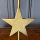 Pair of brass candlesticks decorated with 20th century stars
