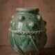 Glazed terracotta urn with protrusions and cordons.