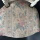 Antique Louis XVI style chair with patinated wood and floral fabric.