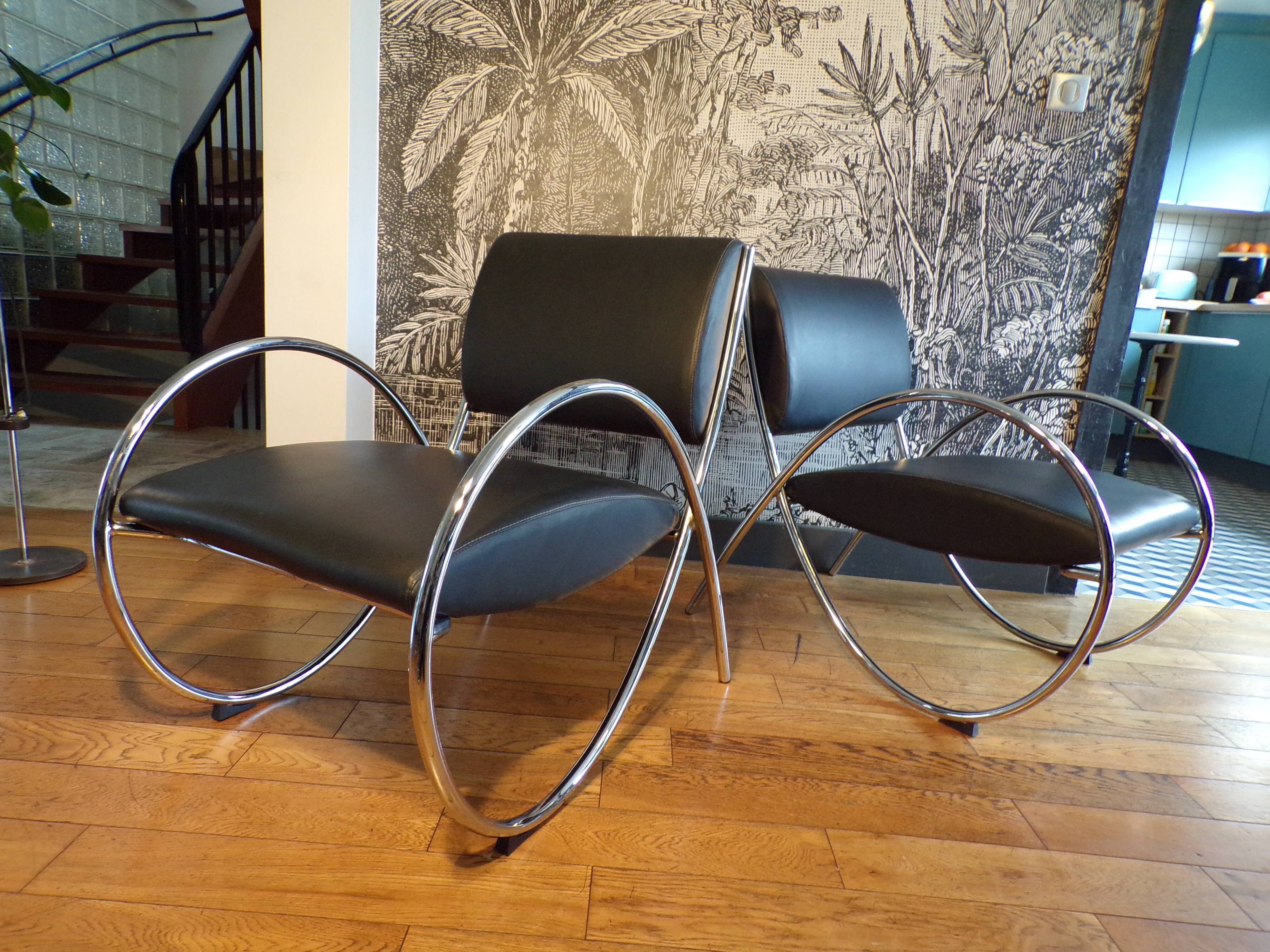 Pair of chrome and faux leather armchairs