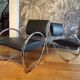 Pair of chrome and faux leather armchairs