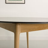 Round table, black lacquered top, solid oak base