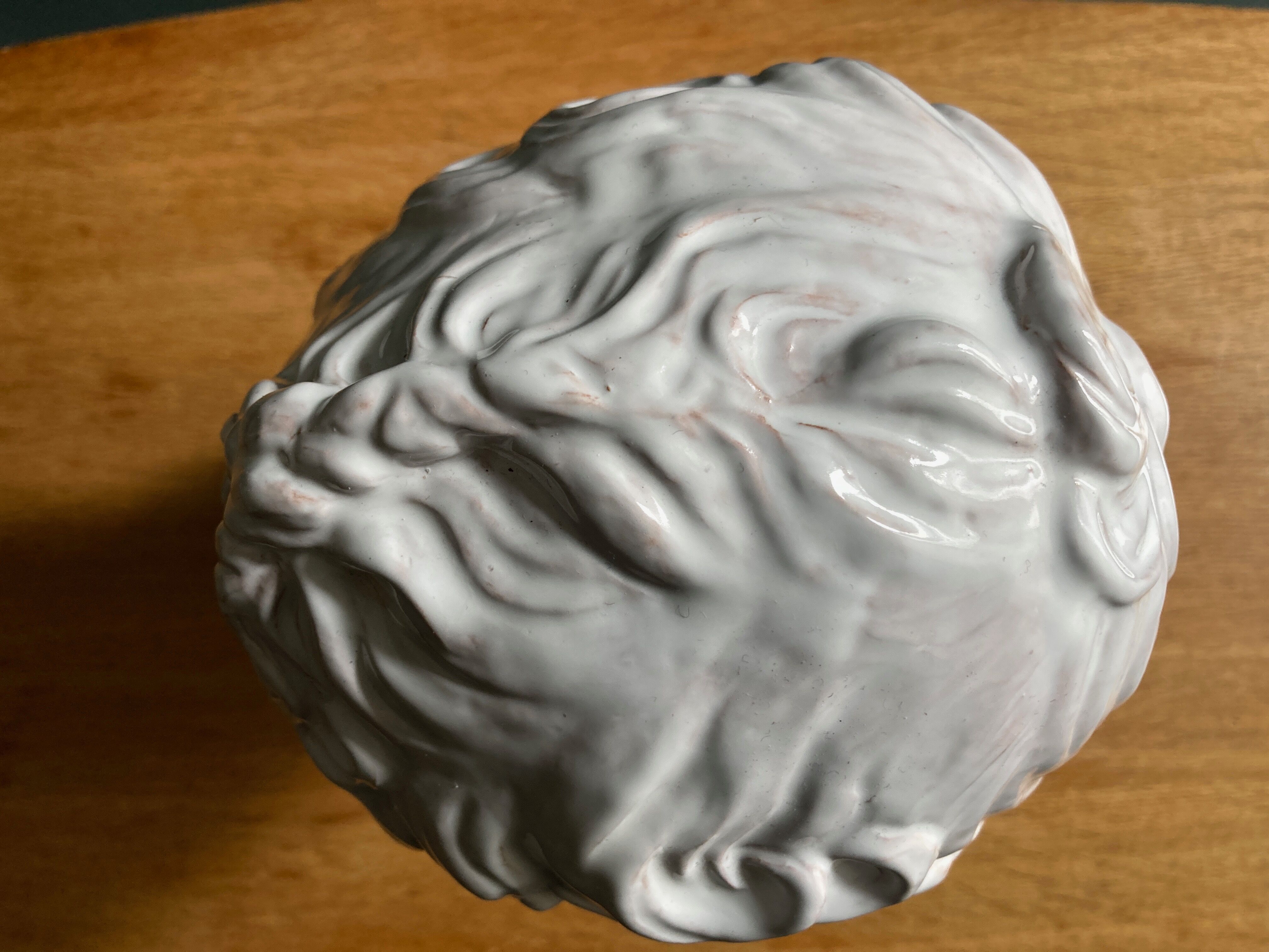 White enamelled terracotta Eros bust