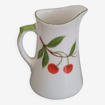 Small ancient porcelain pitcher decorated with cherries