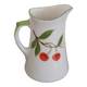 Small ancient porcelain pitcher decorated with cherries