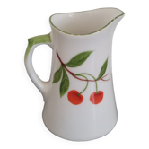 Small ancient porcelain pitcher decorated with cherries