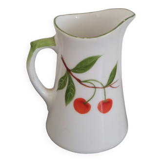 Small ancient porcelain pitcher decorated with cherries