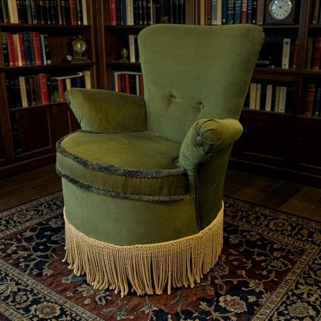 Vintage moss green cocktail chair with fringes.