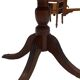 English style round table with green and gold leather top, quadripod with brass claws