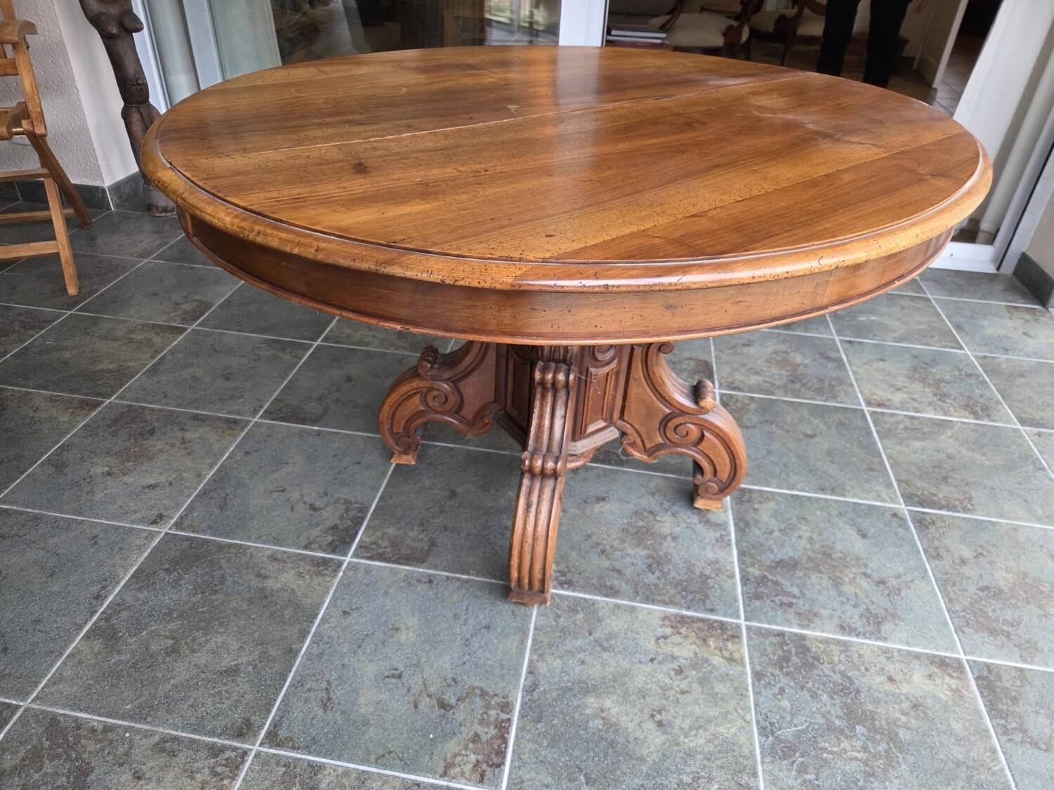 Extendable walnut table in the Napoleon III style.