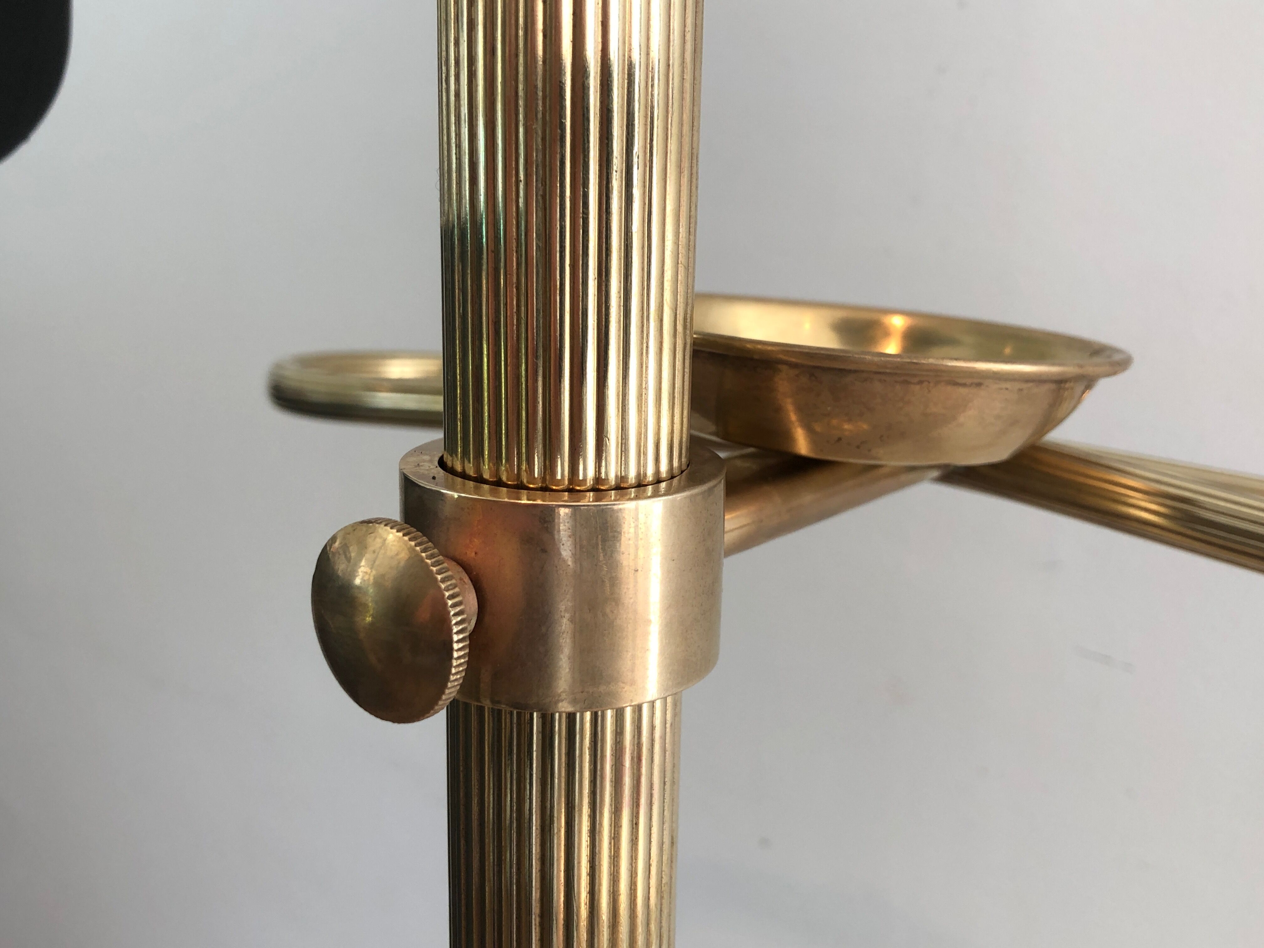 Neoclassical style valet stand in brass and black lacquered wood. French work. Circa 1940