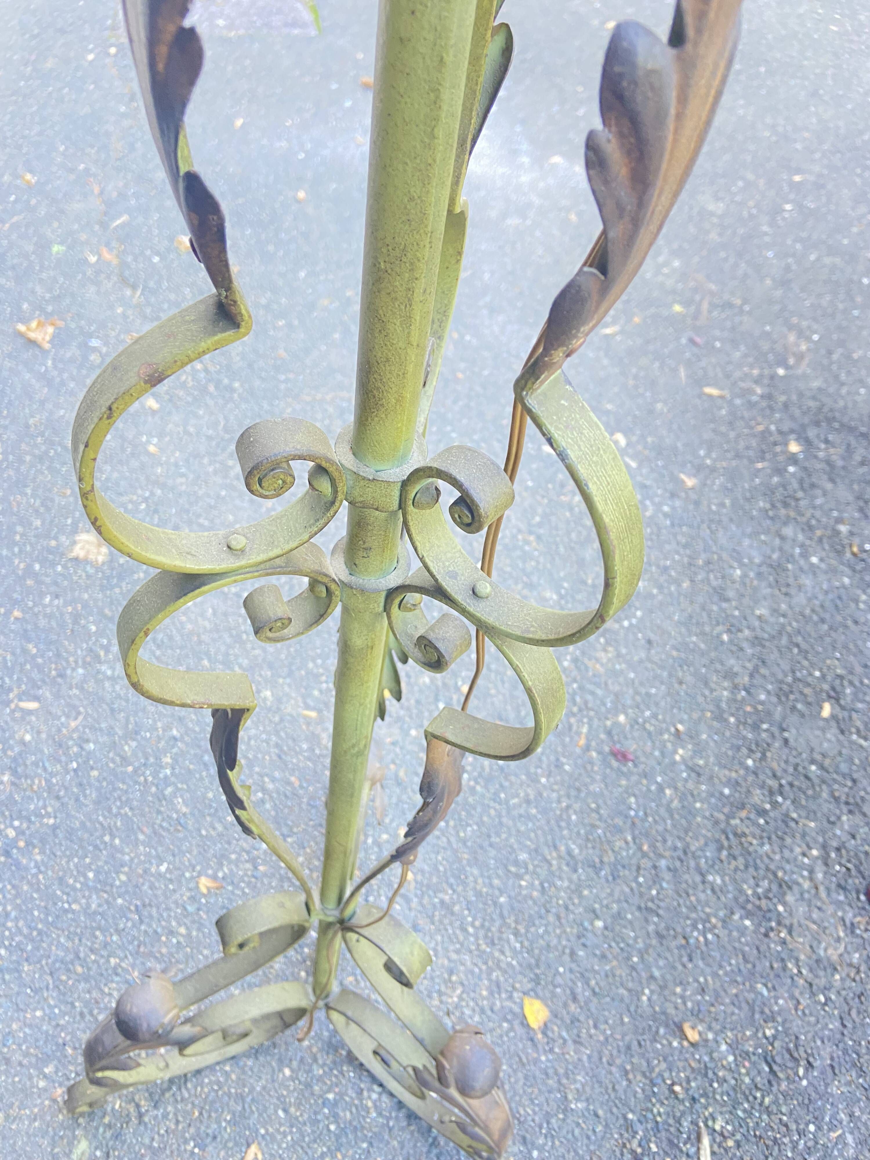 Antique green-painted iron floor lamp with a floral design.
