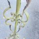 Antique green-painted iron floor lamp with a floral design.