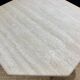 Octagonal table in light travertine