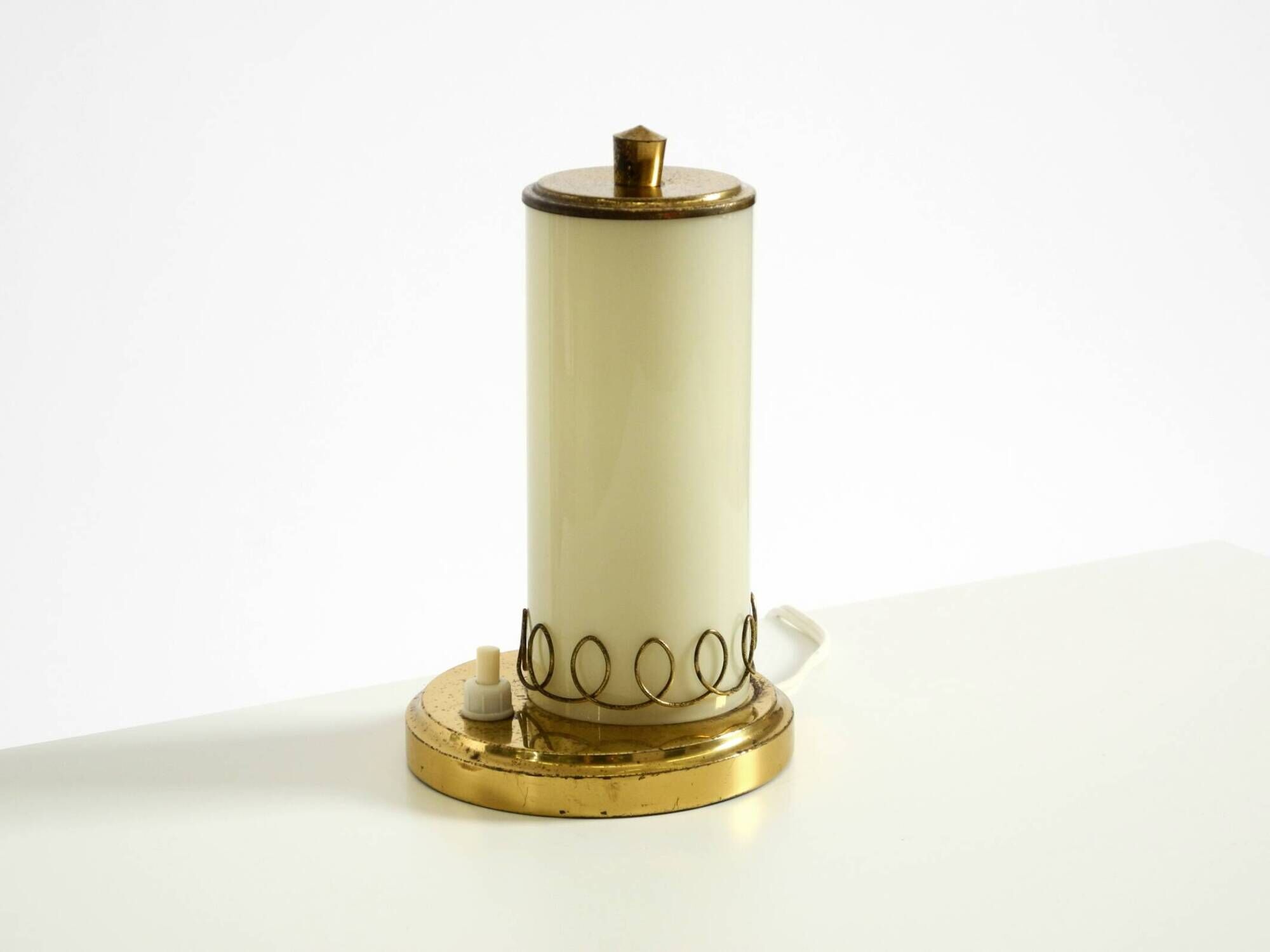 A beautiful, rare 1950s brass table lamp with one opal glass shade adorned