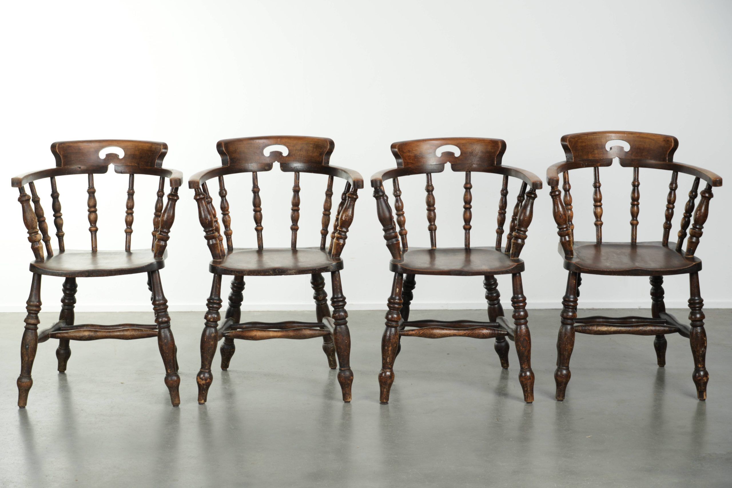 Set of four wooden English antique pub/captain chairs from the 19th century