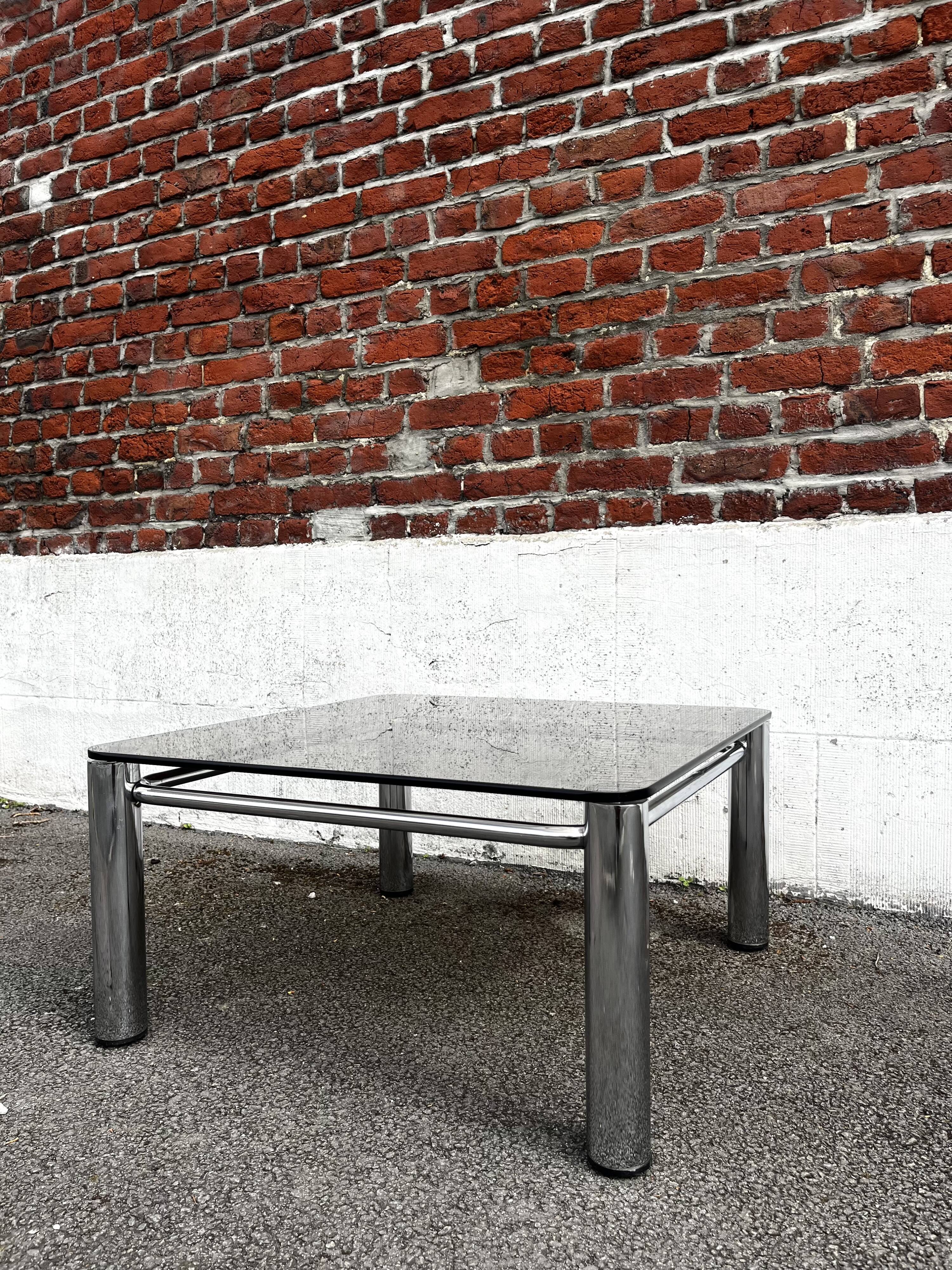 Vintage smoked glass coffee table with chrome structure.