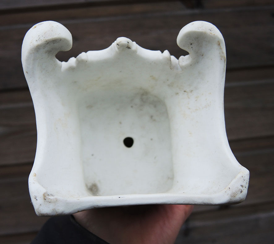 Ancient statuette of the virgin with the serpent in biscuit