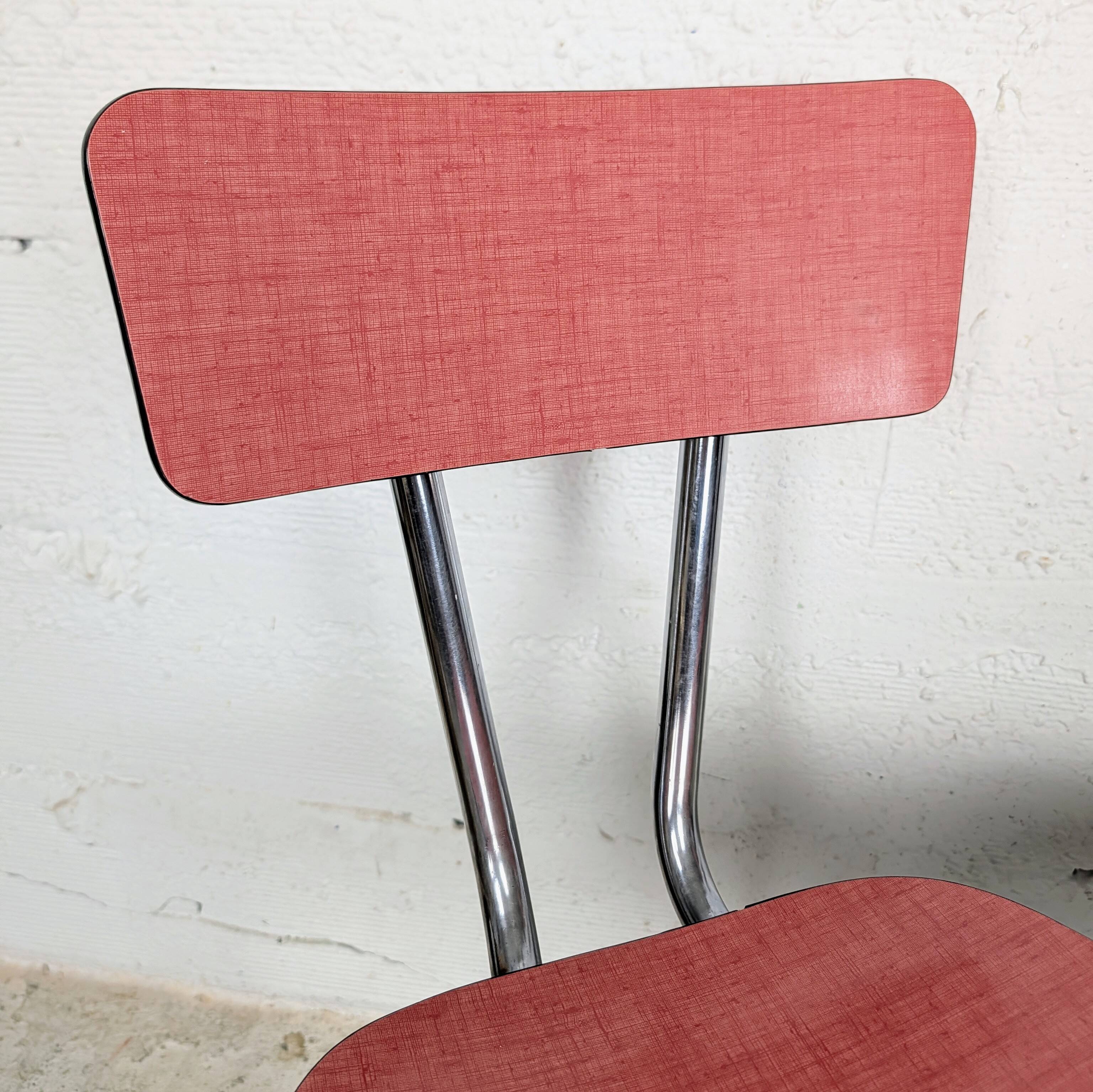 Pair of red Formica chairs with chrome legs