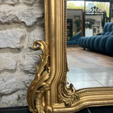 Antique mirror 169/105cm with pediments and pearl detailing in gold leaf.