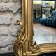 Antique mirror 169/105cm with pediments and pearl detailing in gold leaf.