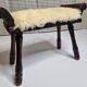 Carved wooden stool covered with Celtic-style sheepskin