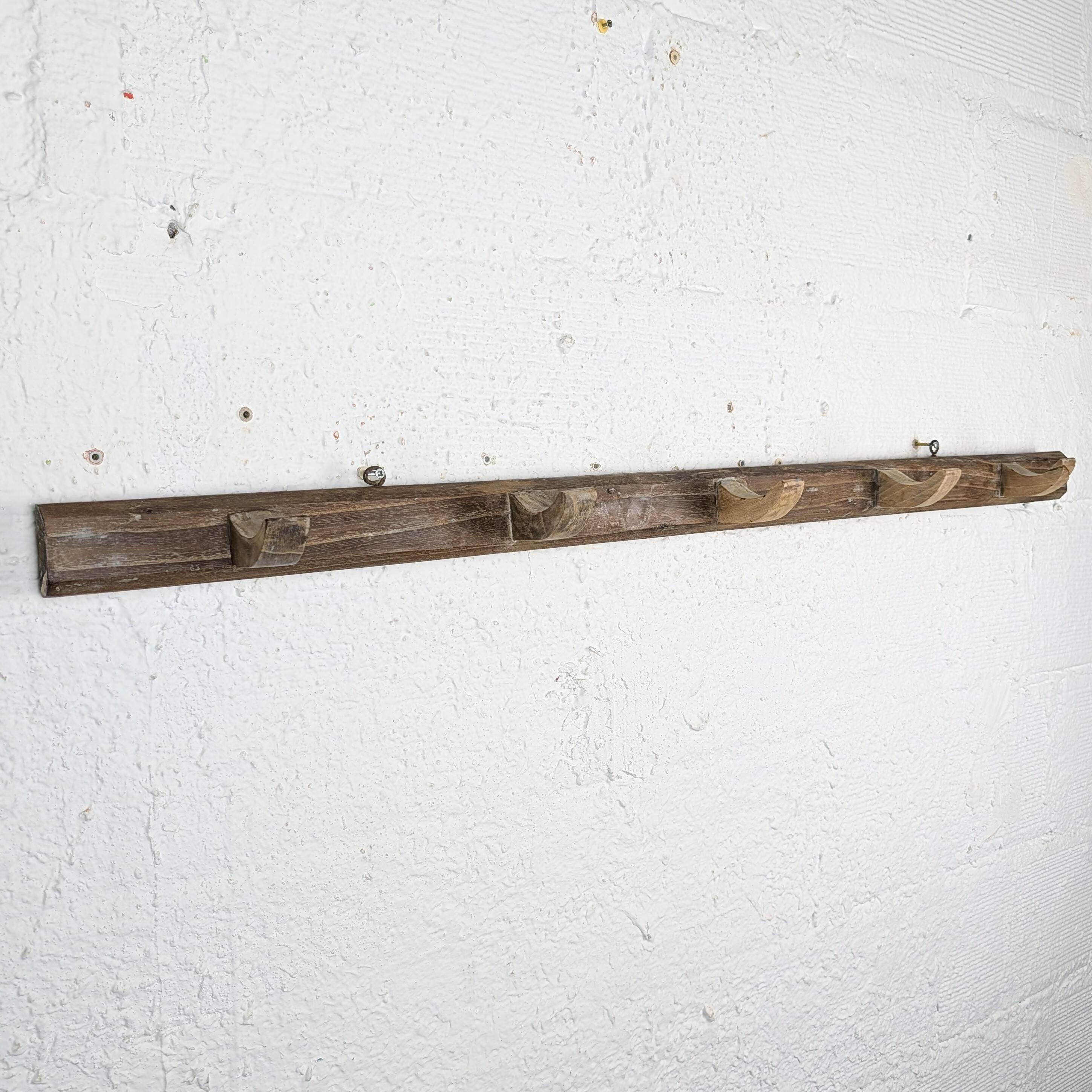 Handcrafted wall coat rack in raw wood