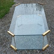 1970s designer coffee table in glass, plexiglass, and gold metal.