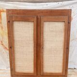 Low cabinet in raw wood and woven raffia