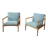 A pair of turquoise armchairs