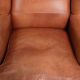 Light cognac-coloured cow leather wingback armchair with matching piping