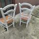Pair of straw-seated chairs with white-stained wood.